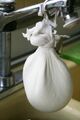 Cottage cheese draining in cheesecloth